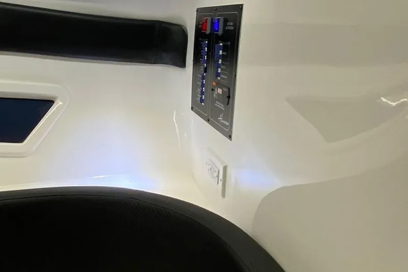  Yacht Photos Pics Interior of a 2025 Hanover 305 with control panel and seating.