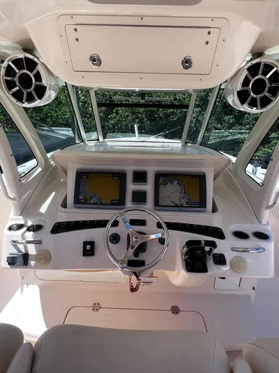  Yacht Photos Pics 2012 Grady-White 366 Canyon boat helm with dual navigation screens and steering wheel.