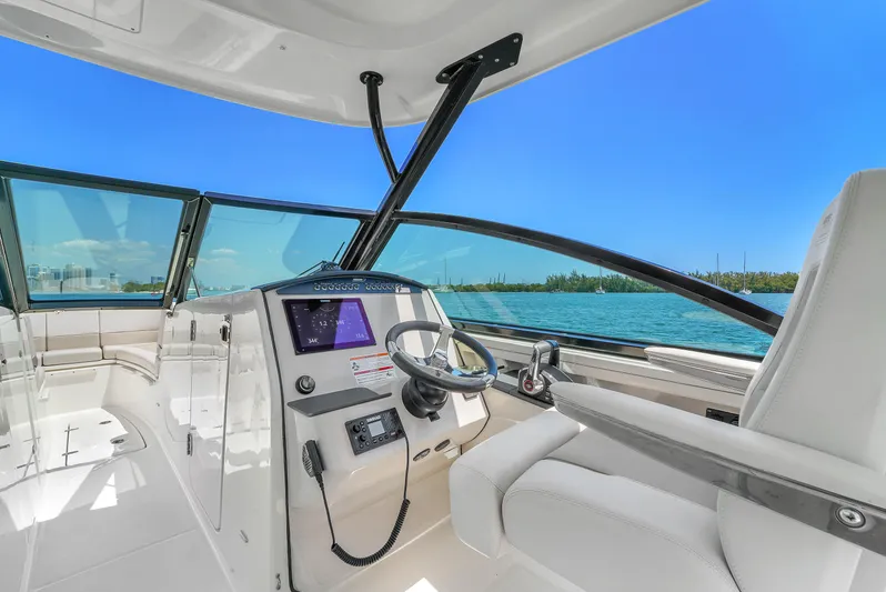  Yacht Photos Pics 2024 Boston Whaler 325 Vantage boat interior with modern dashboard and ocean view.
