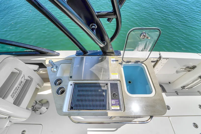  Yacht Photos Pics 2024 Boston Whaler 325 Vantage boat kitchen area with sink and grill.