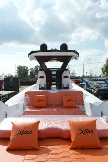  Yacht Photos Pics Luxury DNA 46 yacht, 2025 model, with orange seating and cushions under a cloudy sky.