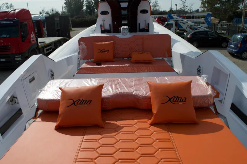  Yacht Photos Pics Luxurious DNA 46 yacht interior with orange cushions, 2025 model, docked outdoors.