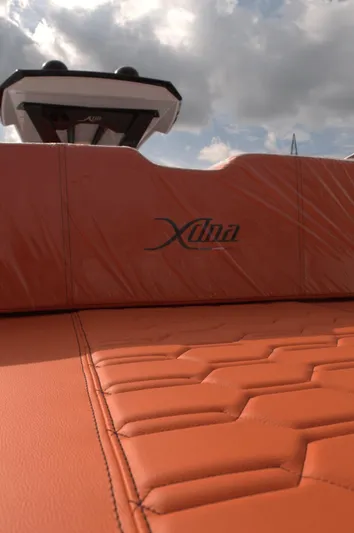  Yacht Photos Pics Orange leather seating on a 2025 DNA 46 boat under a cloudy sky.