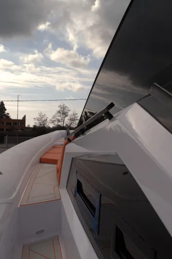  Yacht Photos Pics Modern DNA 46 yacht exterior, 2025 model, with sleek design and cloudy sky backdrop.