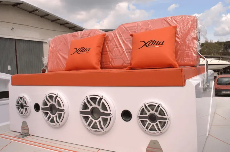  Yacht Photos Pics Orange seating with branded cushions on a DNA 46 boat, featuring four speakers.