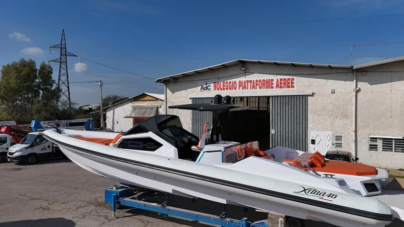  Yacht Photos Pics Boat DNA 46, 2025 model, outside a warehouse under clear blue sky.