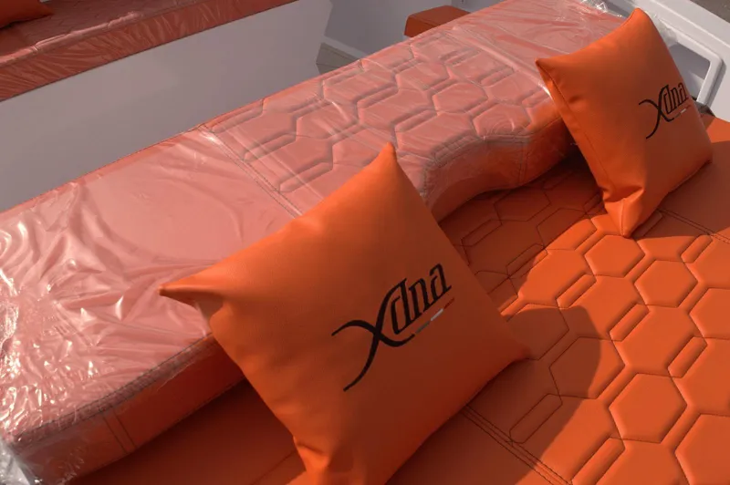  Yacht Photos Pics Orange DNA 46 boat seating with hexagonal pattern and branded cushions, 2025 model.