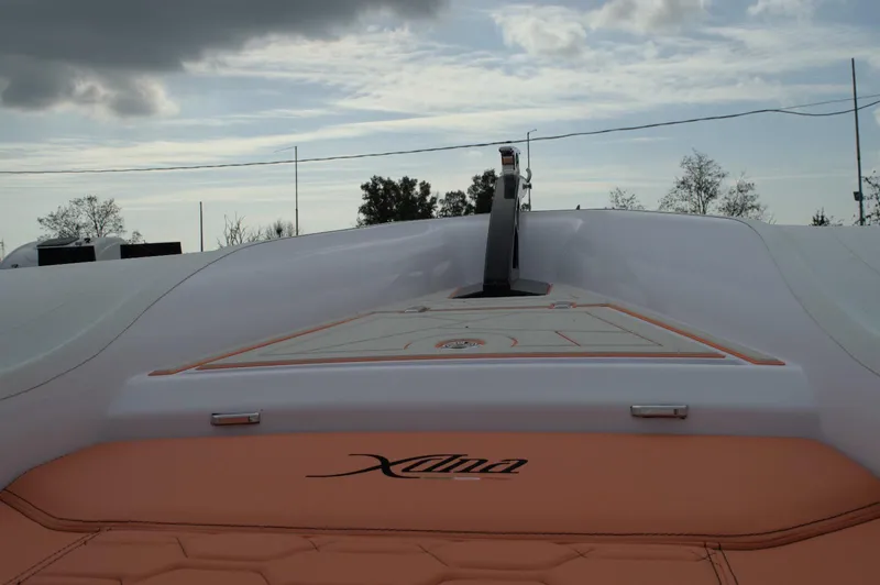  Yacht Photos Pics Modern DNA 46 boat deck, 2025 model, featuring sleek design and orange accents under cloudy sky.