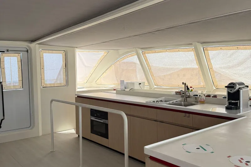 Highland Fling 18 Yacht Photos Pics Modern kitchen interior on 2023 Gunboat 80 yacht, featuring sleek countertops and large windows.
