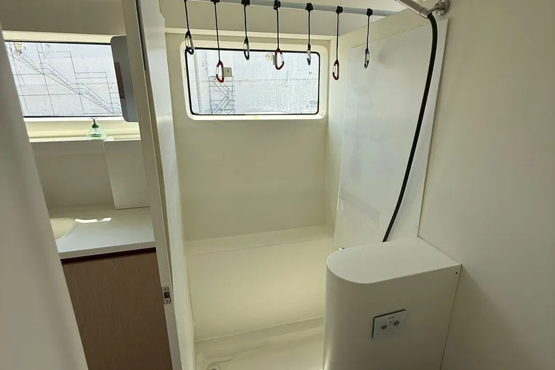 Highland Fling 18 Yacht Photos Pics Interior of 2023 Gunboat 80 yacht featuring a modern shower area with window.