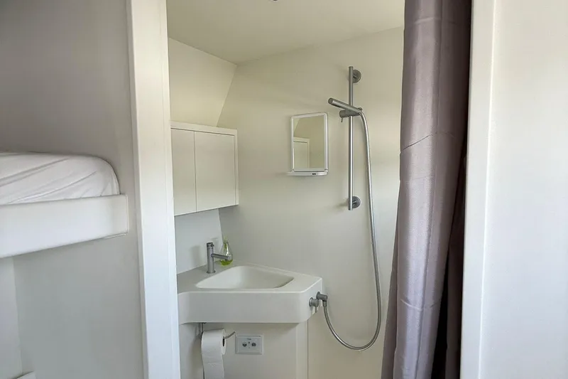 Highland Fling 18 Yacht Photos Pics Modern bathroom in 2023 Gunboat 80 yacht with shower and sink.