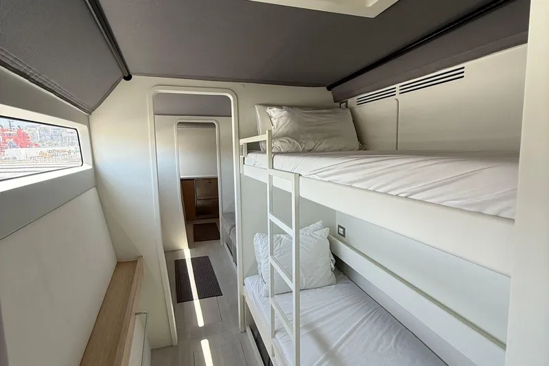 Highland Fling 18 Yacht Photos Pics Modern bunk bed cabin in 2023 Gunboat 80 yacht, featuring sleek design and natural light.
