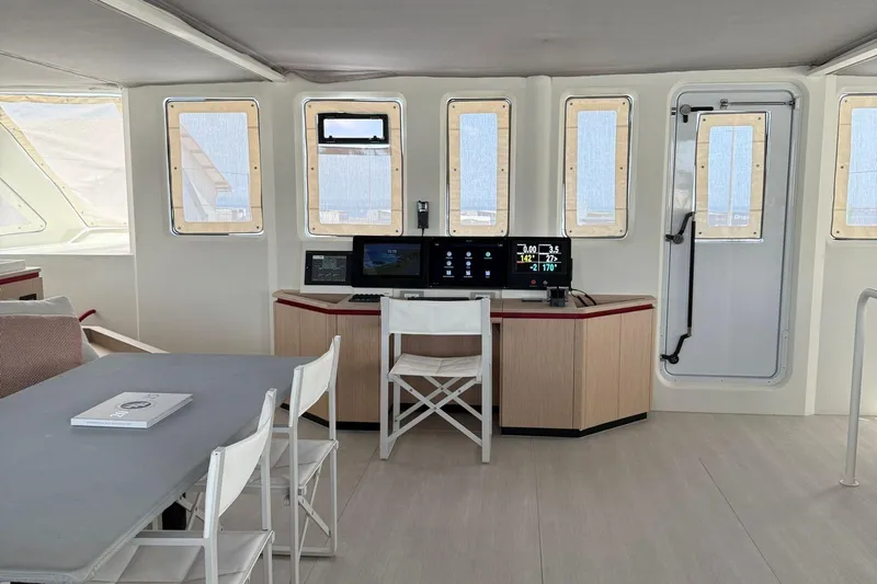 Highland Fling 18 Yacht Photos Pics Interior of 2023 Gunboat 80 yacht featuring navigation station and seating area.