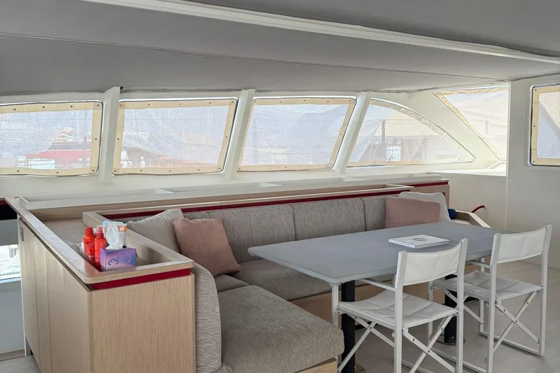 Highland Fling 18 Yacht Photos Pics Luxurious interior of 2023 Gunboat 80 yacht with modern seating and large windows.