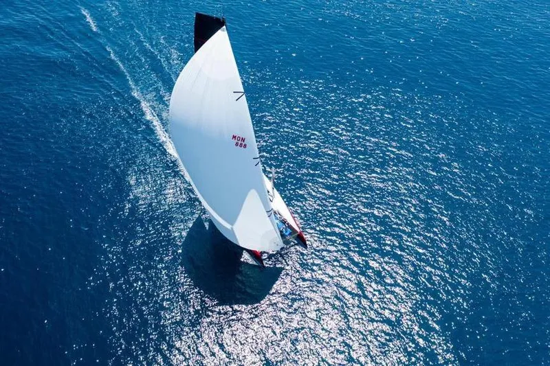 Highland Fling 18 Yacht Photos Pics Aerial view of 2023 Gunboat 80 sailing on clear blue ocean waters.