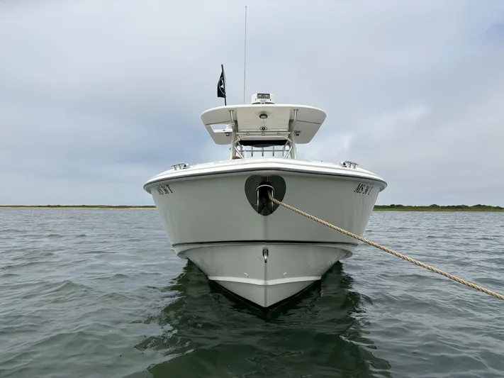 Block It Out Yacht Photos Pics 2005 Boston Whaler 320 Outrage boat anchored on calm water.