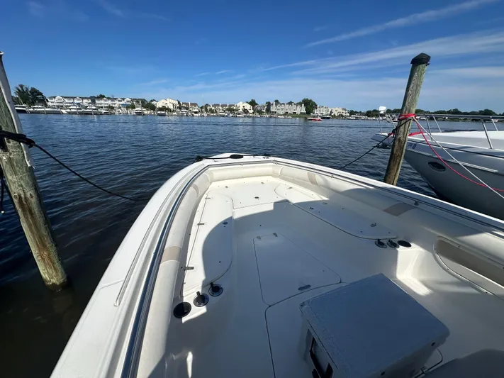 Block It Out Yacht Photos Pics 2005 Boston Whaler 320 Outrage boat docked in a marina under clear blue skies.