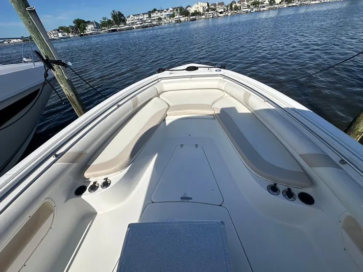 Block It Out Yacht Photos Pics 2005 Boston Whaler 320 Outrage boat interior with seating, docked by the water.