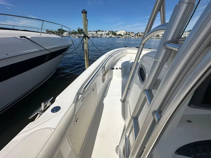 Block It Out Yacht Photos Pics 2005 Boston Whaler 320 Outrage boat docked, showcasing sleek design and spacious deck.