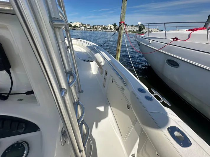 Block It Out Yacht Photos Pics 2005 Boston Whaler 320 Outrage docked, showcasing sleek design and spacious deck.