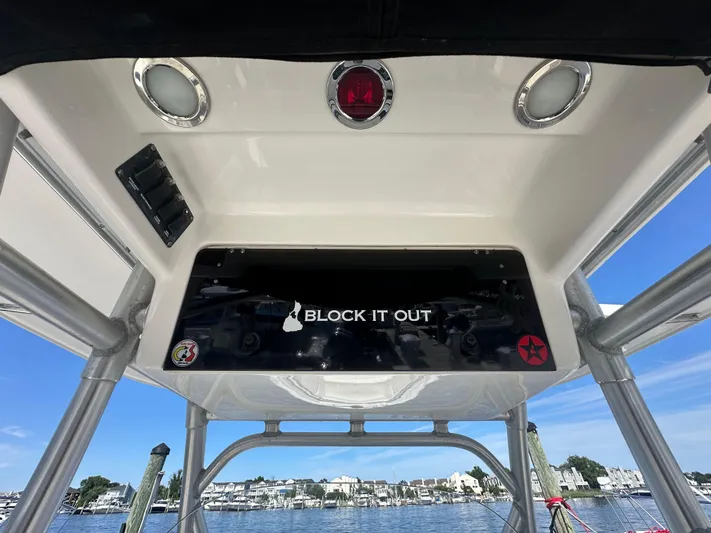 Block It Out Yacht Photos Pics 2005 Boston Whaler 320 Outrage boat console with "Block It Out" decal, dockside view.