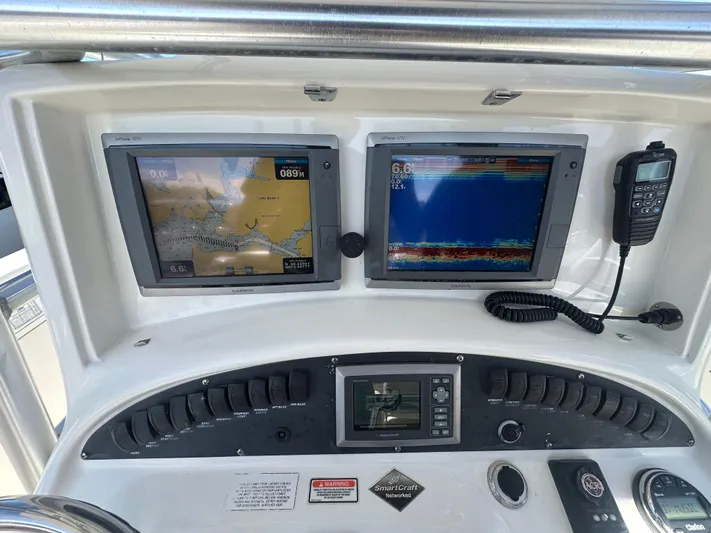 Block It Out Yacht Photos Pics Control panel of a 2005 Boston Whaler 320 Outrage with navigation screens and radio.