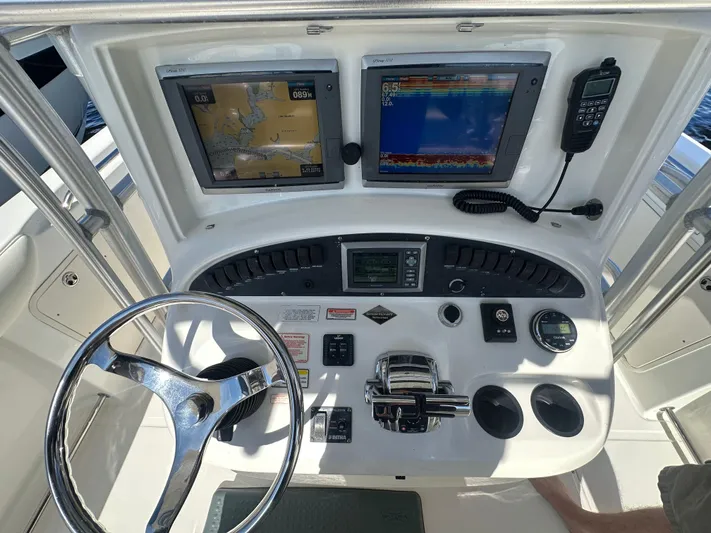 Block It Out Yacht Photos Pics 2005 Boston Whaler 320 Outrage helm with navigation screens and controls.