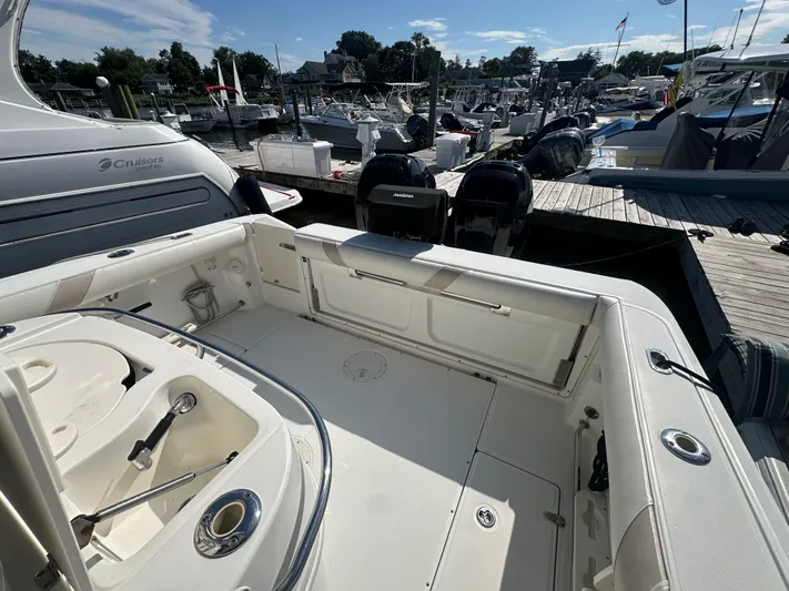 Block It Out Yacht Photos Pics 2005 Boston Whaler 320 Outrage boat docked, featuring spacious deck and twin engines.