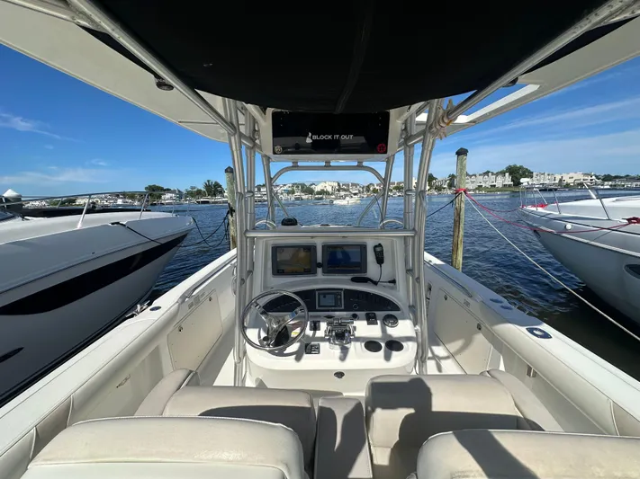 Block It Out Yacht Photos Pics 2005 Boston Whaler 320 Outrage boat interior with steering console, docked at marina.
