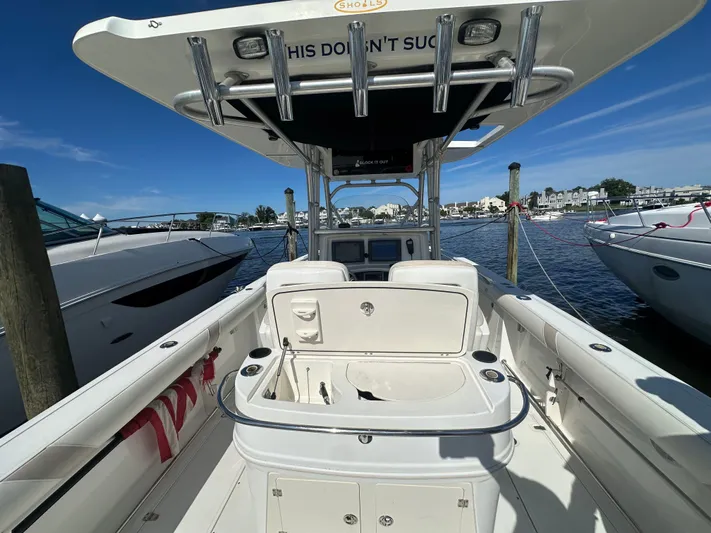 Block It Out Yacht Photos Pics 2005 Boston Whaler 320 Outrage boat docked at marina, clear sky, calm water.