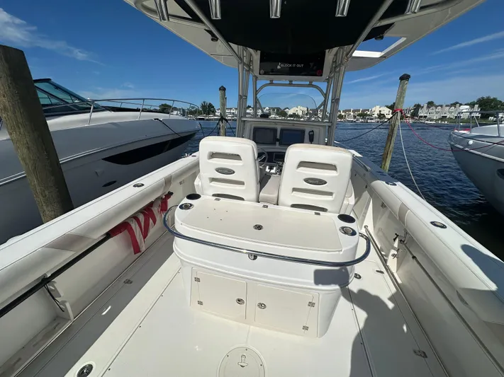 Block It Out Yacht Photos Pics 2005 Boston Whaler 320 Outrage boat interior at dock, featuring helm and seating area.
