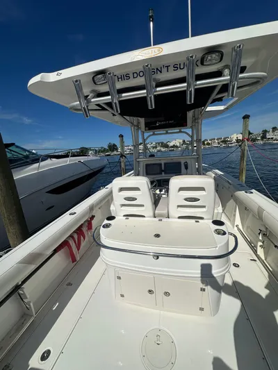 Block It Out Yacht Photos Pics 2005 Boston Whaler 320 Outrage boat interior with seating and storage, docked by the water.