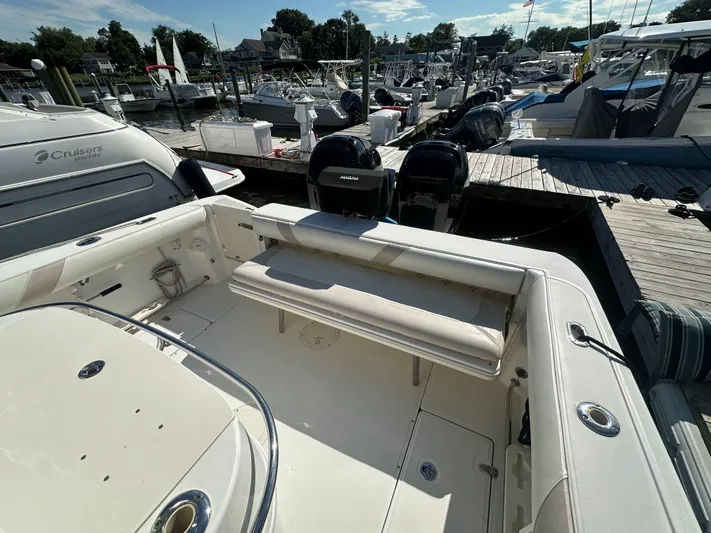 Block It Out Yacht Photos Pics 2005 Boston Whaler 320 Outrage at marina, featuring spacious seating and dual outboard engines.