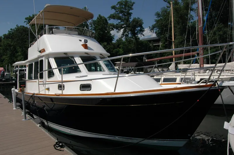 Eight Bells Yacht Photos Pics 2006 Sabre 36 Flybridge Sedan docked at marina, featuring sleek design and spacious flybridge.