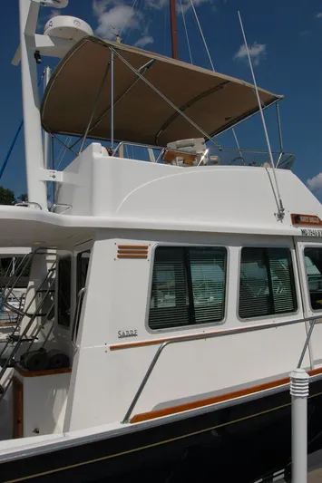 Eight Bells Yacht Photos Pics 2006 Sabre 36 Flybridge Sedan yacht with canopy, docked under a clear blue sky.