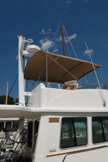 Eight Bells Yacht Photos Pics 2006 Sabre 36 Flybridge Sedan with canopy, docked under clear blue sky.