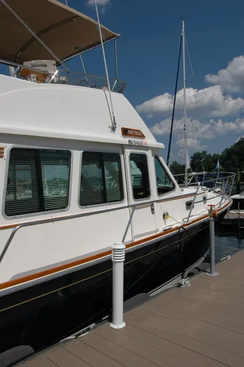 Eight Bells Yacht Photos Pics 2006 Sabre 36 Flybridge Sedan docked at marina under clear blue sky.