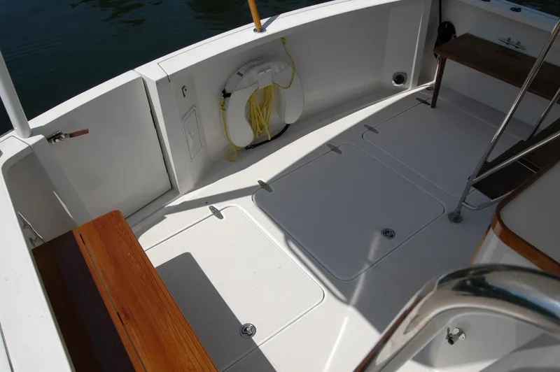Eight Bells Yacht Photos Pics 2006 Sabre 36 Flybridge Sedan deck with wooden seating and life preserver.