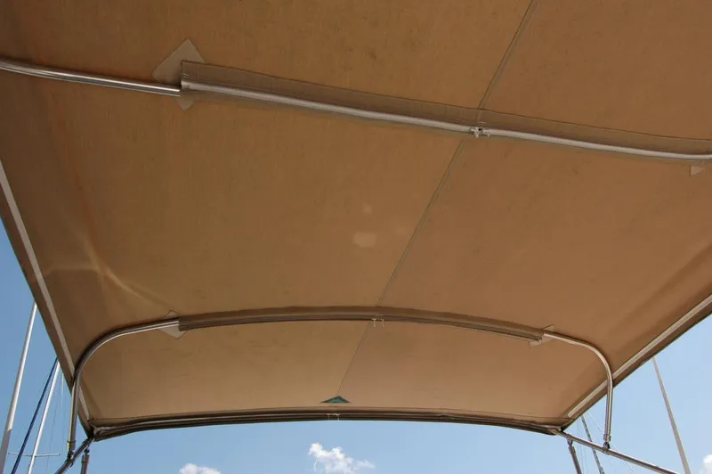 Eight Bells Yacht Photos Pics Bimini top of 2006 Sabre 36 Flybridge Sedan against blue sky.