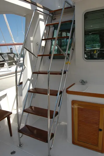 Eight Bells Yacht Photos Pics Stainless steel ladder on 2006 Sabre 36 Flybridge Sedan yacht, leading to upper deck.