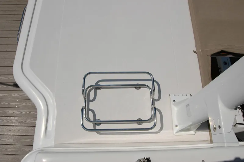 Eight Bells Yacht Photos Pics 2006 Sabre 36 Flybridge Sedan deck with metal railing and beige cover.