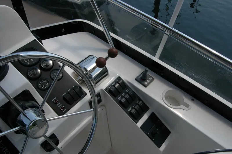 Eight Bells Yacht Photos Pics Helm of 2006 Sabre 36 Flybridge Sedan with steering wheel and control panel.