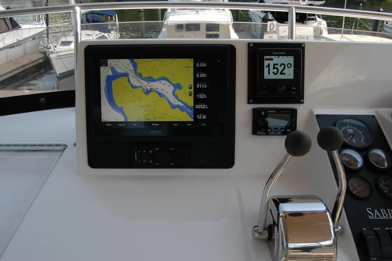 Eight Bells Yacht Photos Pics Control panel of 2006 Sabre 36 Flybridge Sedan with navigation and throttle controls.