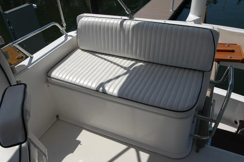 Eight Bells Yacht Photos Pics White cushioned seating on 2006 Sabre 36 Flybridge Sedan boat deck.