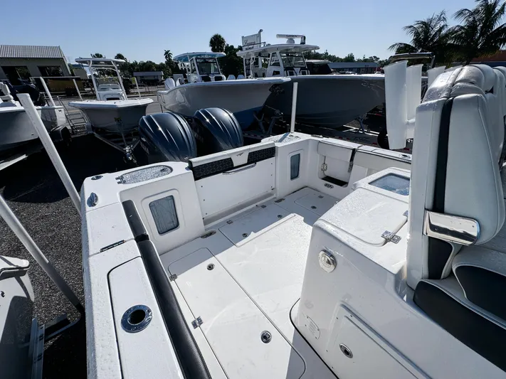 Yacht Photos Pics 2023 Tidewater 282cc Adventure Bluewater boat interior with dual engines, docked outdoors.