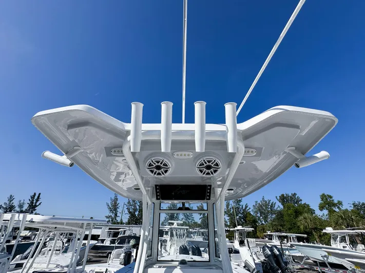  Yacht Photos Pics 2023 Tidewater 282cc Adventure Bluewater boat with T-top and rod holders under clear sky.