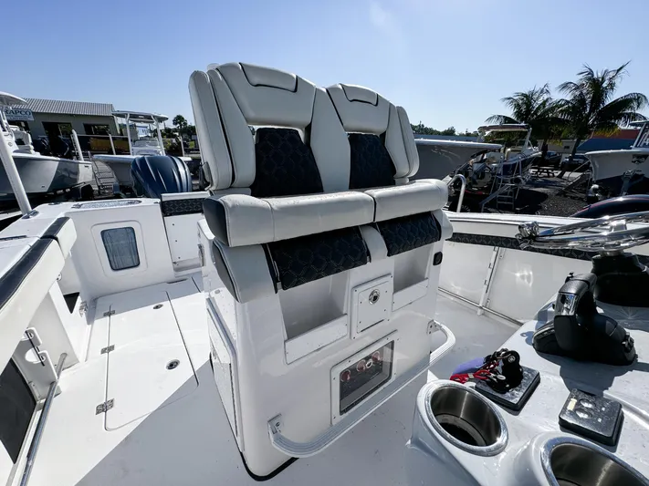  Yacht Photos Pics 2023 Tidewater 282cc Adventure Bluewater boat interior with dual seats and control panel.