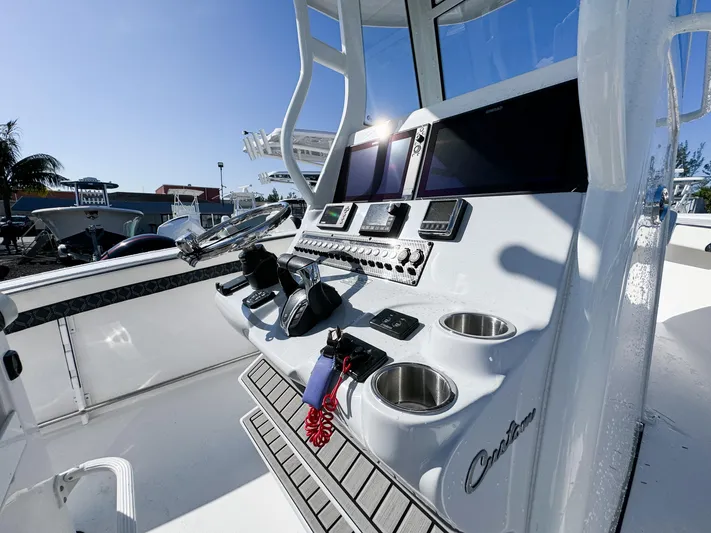  Yacht Photos Pics 2023 Tidewater 282cc Adventure Bluewater boat console with modern controls and dual screens.