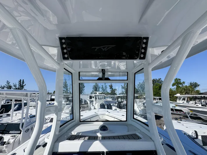  Yacht Photos Pics 2023 Tidewater 282cc Adventure Bluewater boat interior with console and clear view of marina.