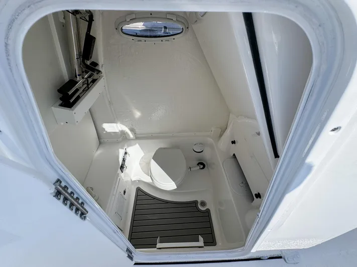  Yacht Photos Pics 2023 Tidewater 282cc Adventure Bluewater boat interior with compact marine toilet.